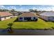 Aerial view of a tranquil waterfront property with lush landscaping at 24276 Buckingham Way, Port Charlotte, FL 33980