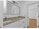 Double vanity bathroom with granite countertop and modern fixtures at 24083 Buckingham Way, Port Charlotte, FL 33980