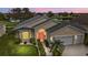 Attractive single-Gathering home with two-car garage, nicely landscaped at 24083 Buckingham Way, Port Charlotte, FL 33980