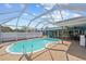 Refreshing kidney-shaped pool with screened enclosure at 156 Morgan Se Ln, Port Charlotte, FL 33952
