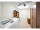 Bright laundry room, washer, dryer, cabinets, and built-in shelving at 156 Morgan Se Ln, Port Charlotte, FL 33952