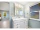 Bathroom with white vanity, single sink, and mirrored medicine cabinet at 156 Morgan Se Ln, Port Charlotte, FL 33952