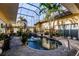 Enclosed pool and patio area with lush tropical landscaping at 1209 San Mateo Dr, Punta Gorda, FL 33950