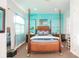 Bright bedroom with a comfortable four-poster bed and teal walls at 1209 San Mateo Dr, Punta Gorda, FL 33950