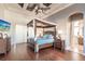 Main bedroom with four-poster bed, hardwood floors, and ensuite bathroom access at 1209 San Mateo Dr, Punta Gorda, FL 33950