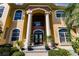Elegant home entrance featuring columns and a double door at 1209 San Mateo Dr, Punta Gorda, FL 33950