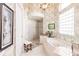 Bathroom with a large soaking tub, walk-in shower, and elegant wallpaper at 1209 San Mateo Dr, Punta Gorda, FL 33950