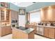 Island kitchen with granite countertops and stainless steel appliances at 1209 San Mateo Dr, Punta Gorda, FL 33950