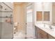 Elegant bathroom with a walk-in shower, double vanity, and access to bedroom at 1209 San Mateo Dr, Punta Gorda, FL 33950