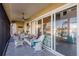 Screened lanai with wicker furniture and waterfront view at 1209 San Mateo Dr, Punta Gorda, FL 33950