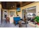 Covered patio with seating area, wet bar, and pool access at 1209 San Mateo Dr, Punta Gorda, FL 33950