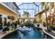 Inviting pool area with lush landscaping and a covered patio at 1209 San Mateo Dr, Punta Gorda, FL 33950