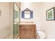 Bathroom with walk-in shower and wood vanity at 1209 San Mateo Dr, Punta Gorda, FL 33950