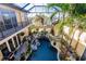 Inviting kidney-shaped pool with lush landscaping at 1209 San Mateo Dr, Punta Gorda, FL 33950