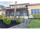 Landscaped backyard with a screened porch and walkway at 1209 San Mateo Dr, Punta Gorda, FL 33950