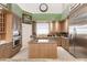 Modern kitchen featuring stainless steel appliances and light wood cabinets at 1209 San Mateo Dr, Punta Gorda, FL 33950
