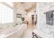 Bathroom with a large soaking tub and a view into another bathroom area at 1209 San Mateo Dr, Punta Gorda, FL 33950