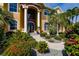 Inviting home exterior with lush landscaping and a brick pathway at 1209 San Mateo Dr, Punta Gorda, FL 33950