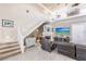 Spacious living room with a fireplace and staircase at 1209 San Mateo Dr, Punta Gorda, FL 33950