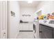 Clean laundry room with washer, dryer, and ample cabinet space at 1209 San Mateo Dr, Punta Gorda, FL 33950