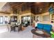 Covered patio with seating area, wet bar, and pool access at 1209 San Mateo Dr, Punta Gorda, FL 33950
