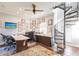 Bright office with large desk, wall of framed achievements, and spiral staircase at 1209 San Mateo Dr, Punta Gorda, FL 33950