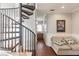 Upper-level landing with spiral staircase and sitting area at 1209 San Mateo Dr, Punta Gorda, FL 33950