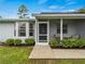 Front entrance with a covered porch and landscaping at 3833 Lorton Ave, North Port, FL 34286