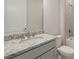 Bathroom with granite countertop, gray vanity, and oval sink at 16024 Crofton Springs Way, Port Charlotte, FL 33953