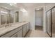 Double vanity bathroom with granite countertop and walk-in shower at 16024 Crofton Springs Way, Port Charlotte, FL 33953