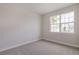 Bright bedroom with neutral walls and carpet, featuring a large window at 16024 Crofton Springs Way, Port Charlotte, FL 33953
