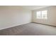 Well-lit bedroom with neutral walls and carpet, offering ample space at 16024 Crofton Springs Way, Port Charlotte, FL 33953