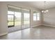 Bright dining room with tile floors and sliding glass doors to backyard at 16024 Crofton Springs Way, Port Charlotte, FL 33953