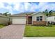 Single-story home with a two-car garage and attractive landscaping at 16024 Crofton Springs Way, Port Charlotte, FL 33953