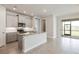 Modern kitchen featuring an island, granite countertops, and gray cabinets at 16024 Crofton Springs Way, Port Charlotte, FL 33953