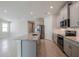 Open concept kitchen with island, stainless steel appliances, and granite countertops at 16024 Crofton Springs Way, Port Charlotte, FL 33953