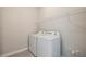 Laundry room with washer, dryer, and overhead shelving at 16024 Crofton Springs Way, Port Charlotte, FL 33953
