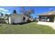 Landscaped side yard showcasing a storage shed and screened porch at 18939 Ayrshire Cir, Port Charlotte, FL 33948