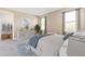 Serene bedroom featuring two windows, walk-in closet, and neutral decor create a tranquil retreat at 25228 Rampart Blvd, Punta Gorda, FL 33983