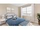 Inviting bedroom boasts a large window for natural light and a soothing color scheme for relaxation at 25228 Rampart Blvd, Punta Gorda, FL 33983