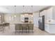 Modern kitchen with island, granite countertops, stainless steel appliances, and pendant lighting at 25228 Rampart Blvd, Punta Gorda, FL 33983