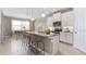 Modern kitchen featuring an island with seating, white cabinetry, and stainless steel appliances at 25228 Rampart Blvd, Punta Gorda, FL 33983