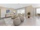 Bright living room features stylish furnishings, a neutral color palette, and sliding glass doors to the lanai at 25228 Rampart Blvd, Punta Gorda, FL 33983