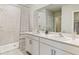 Bright bathroom with double vanity sinks, tiled shower, and ample counter space at 25236 Rampart Blvd, Punta Gorda, FL 33983