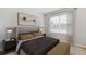 Cozy bedroom with a window offering natural light, complemented by tasteful decor at 25236 Rampart Blvd, Punta Gorda, FL 33983
