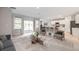 Spacious living area flows into kitchen with white cabinets, island, and outdoor access at 25236 Rampart Blvd, Punta Gorda, FL 33983