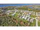 Aerial view of residential community with lake, and many well-maintained homes at 4255 Oak Terrace Cir, Port Charlotte, FL 33953