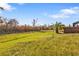 Spacious backyard with lush grass and an enclosed screened in lanai on the house at 4255 Oak Terrace Cir, Port Charlotte, FL 33953