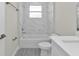 Bathroom featuring marble wall, white vanity, and a bathtub with brushed nickel fixtures at 4255 Oak Terrace Cir, Port Charlotte, FL 33953