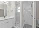 Bathroom featuring a shower with glass door, white vanity, and stylish fixtures at 4255 Oak Terrace Cir, Port Charlotte, FL 33953
